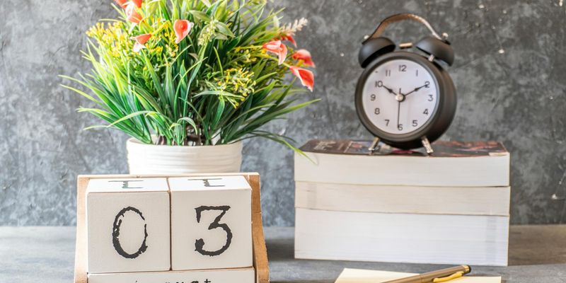 A calendar and a yoga mat, symbolizing the integration of practice into a daily schedule.